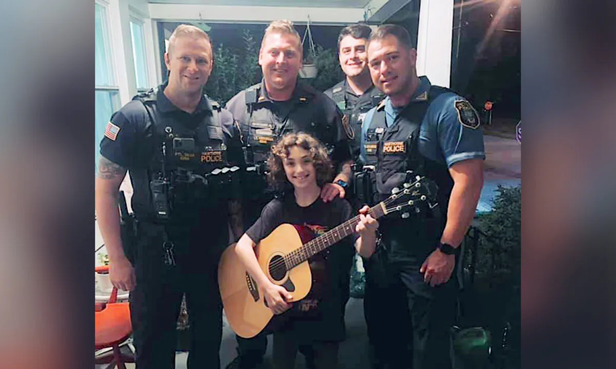 (Back, L–R) Officers Andrew Skae, Lt. Benjamin Veenema, Kevin Foley, and Marc Lecourieux with Evan.(Courtesy of Hawthorne Police Department)