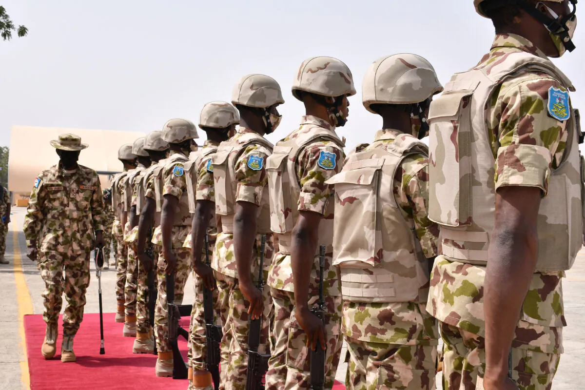 Chief of Defense Staff Major General Leo Irabor (L) inspects soldiers standing on attention during a guard of honour for the newly appointed Nigerian military chiefs' arrival at the Maiduguri Airforce base in Maiduguri, Nigeria, on January 31, 2021. (Audu Marte/AFP via Getty Images)