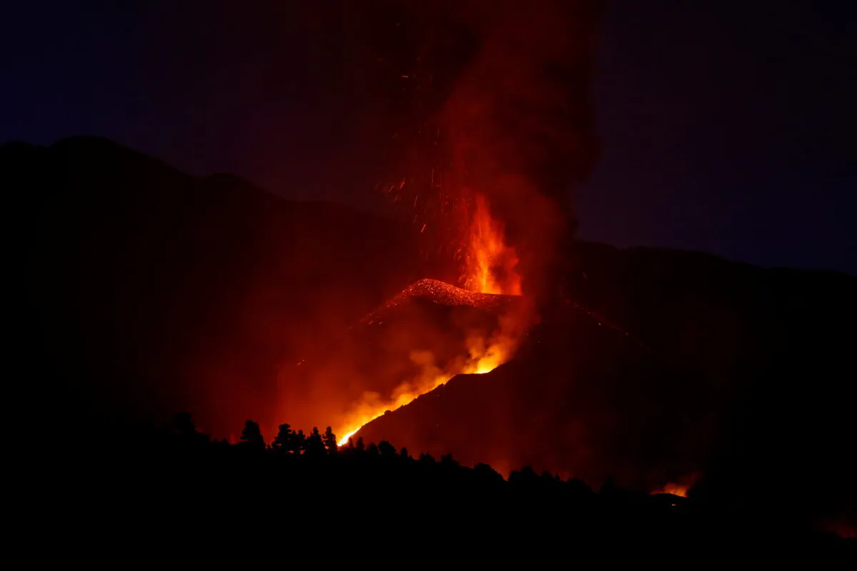 The Cumbre Vieja volcano spews lava as it continues to erupt on the Canary Island of La Palma, as seen from Tajuya, Spain, on Oct. 17, 2021. (Susana Vera/Reuters)