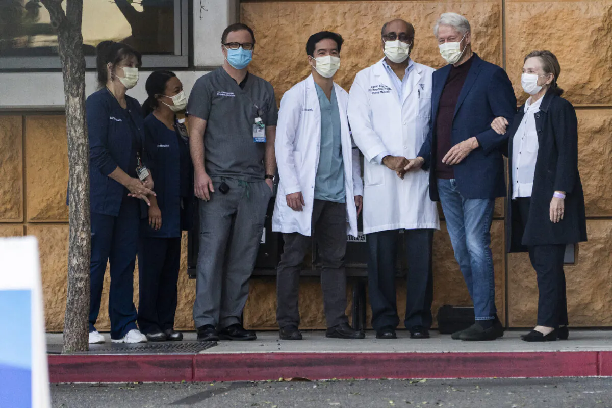 Former President Bill Clinton and former First Lady and Secretary of State Hillary Clinton thank Alpesh N. Amin, MD, third from right, and the medical staff as the former president is released from the University of California–Irvine Medical Center in Orange County, Calif., on Oct. 17, 2021. (Damian Dovarganes/AP Photo)