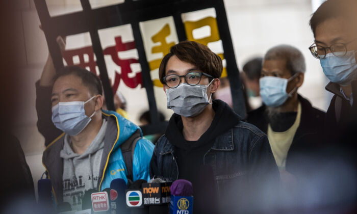 Former Convener of Civil Human Rights Front Figo Chan (C) talks to the media outside West Kowloon Court in Hong Kong on Dec. 17, 2020. (Isaac Lawrence/AFP)