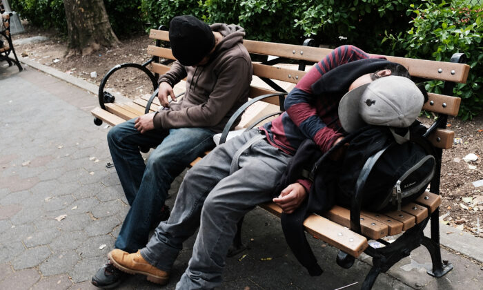 Men sit passed out in a park where heroin users gather to shoot up in the Bronx, New York City, on May 4, 2018. (Spencer Platt/Getty Images)