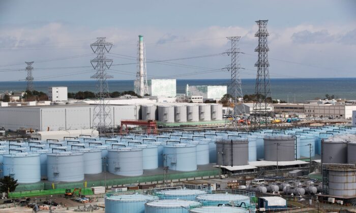 Nuclear reactors of No. 5 (C-L), and 6 look over tanks storing water that was treated but still radioactive, at the Fukushima Daiichi nuclear power plant in Okuma town, Fukushima prefecture, northeastern Japan on Feb. 27, 2021. (Hiro Komae/AP Photo)