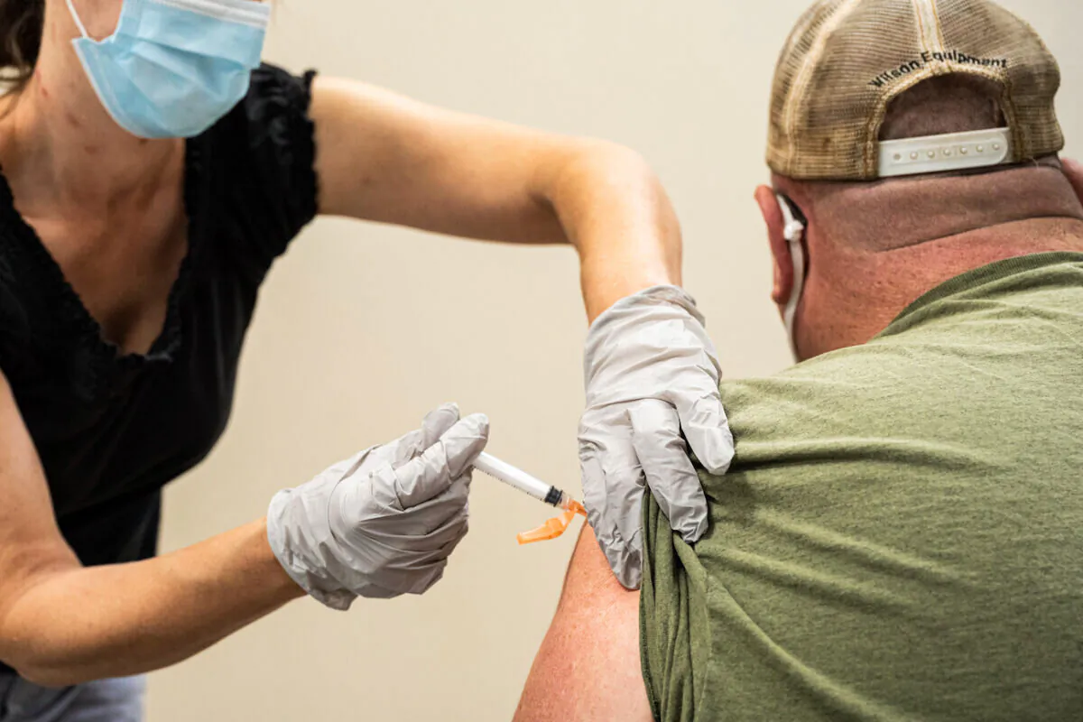 A civilian contractor receives a COVID-19 vaccine from Preventative Medicine Services in Fort Knox, Ky.,  on Sept. 9, 2021. (Jon Cherry/Getty Images)