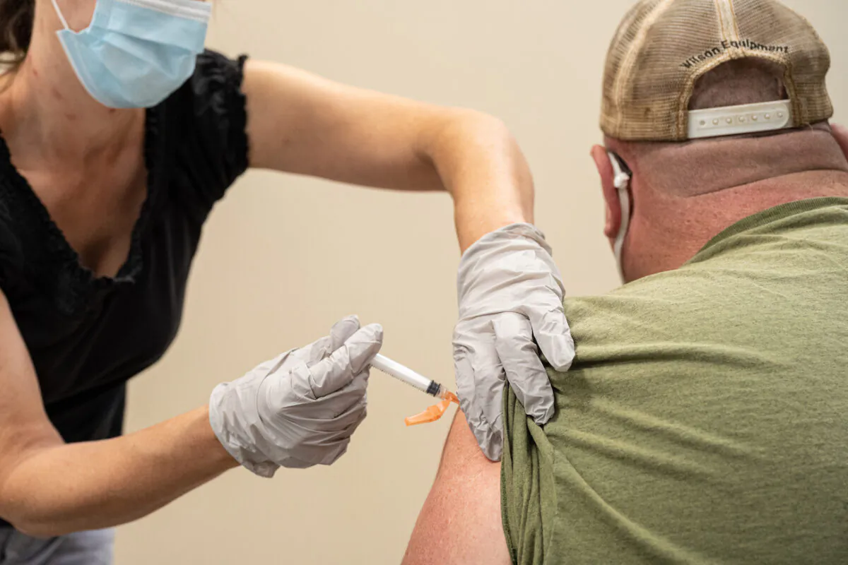 A civilian contractor receives his COVID-19 vaccine from Preventative Medicine Services in Fort Knox, Ky., on Sept. 9, 2021. (Jon Cherry/Getty Images)