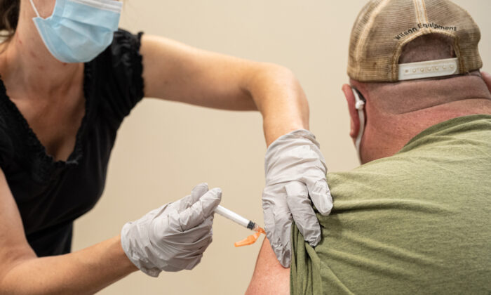 A civilian contractor receives his COVID-19 vaccine from Preventative Medicine Services in Fort Knox, Ky., on Sept. 9, 2021. (Jon Cherry/Getty Images)