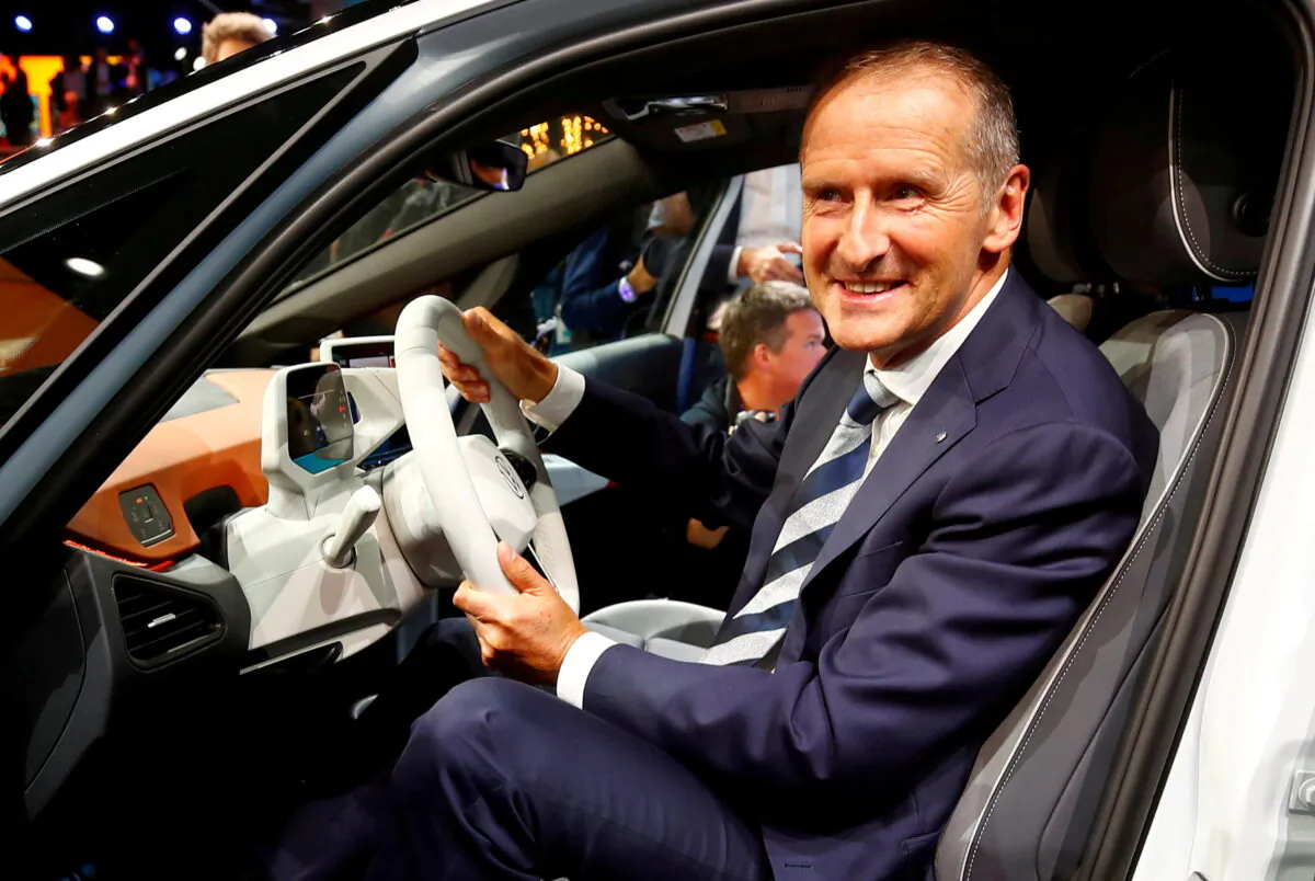 Herbert Diess, CEO of German carmaker Volkswagen AG, poses in an ID.3 pre-production prototype during the presentation of Volkswagen's new electric car on the eve of the International Frankfurt Motor Show IAA in Frankfurt, Germany, on Sept. 9, 2019. (Wolfgang Rattay/Reuters)