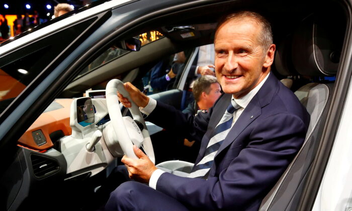 Herbert Diess, CEO of German carmaker Volkswagen AG, poses in an ID.3 pre-production prototype during the presentation of Volkswagen's new electric car on the eve of the International Frankfurt Motor Show IAA in Frankfurt, Germany, on  Sept. 9, 2019. (Wolfgang Rattay/Reuters)