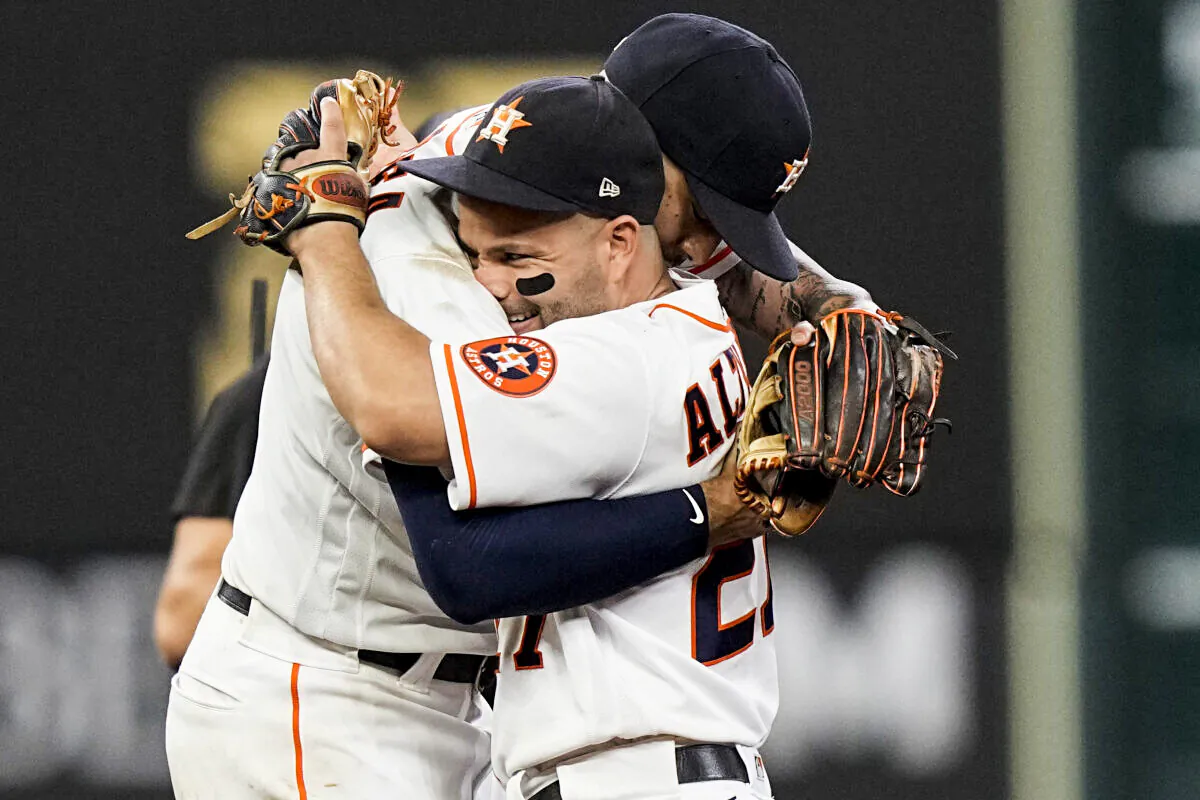 Houston Astros shortstop Carlos Correa celebrates their win with Jose Altuve against the Boston Red Sox in Game 1 of baseball's American League Championship Series in Houston on Oct. 15, 2021. (David J. Phillip/AP Photo)
