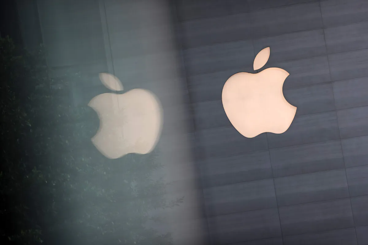 An Apple logo is reflected on glass at the Apple Store at Orchard Road in Singapore, on Sept. 24, 2021. (Feline Lim/Getty Images)