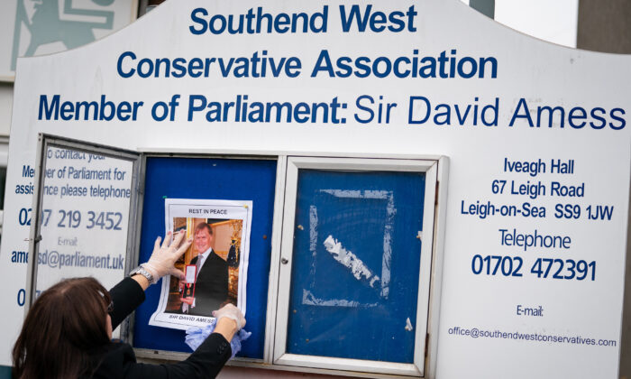 A photograph of late Sir David Amess is placed on a noticeboard outside the Iveagh Hall, the home of the Southend West Conservative Association in Leigh-on-Sea, Essex, England, on Oct. 18, 2021. (Aaron Chown/PA)
