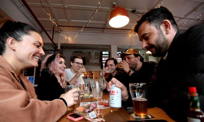 People enjoy their drinks at a pub in Sydney, Australia, on Oct. 11, 2021, (Saeed Khan/AFP via Getty Images)
