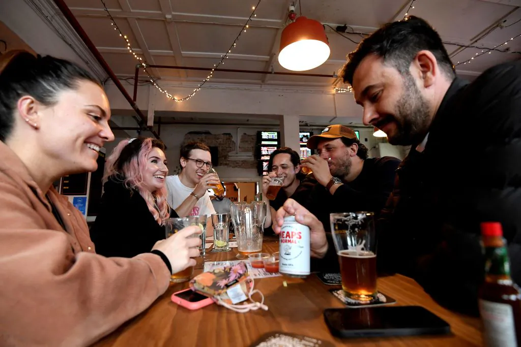 People enjoy their drinks at a pub in Sydney, Australia, on Oct. 11, 2021, (Saeed Khan/AFP via Getty Images)
