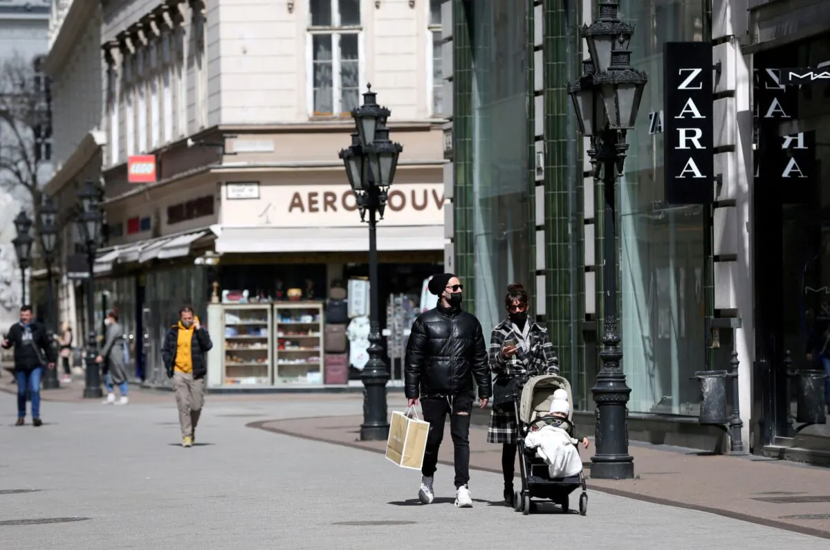 People walk in a shopping street as shops reopen amid the coronavirus disease (COVID-19) pandemic in downtown Budapest, Hungary on April 7, 2021. (Bernadett Szabo/Reuters)