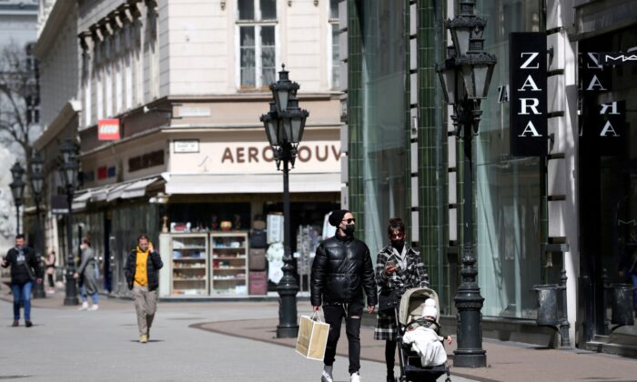 People walk in a shopping street as shops reopen amid the coronavirus disease (COVID-19) pandemic in downtown Budapest, Hungary on April 7, 2021. (Bernadett Szabo/Reuters)