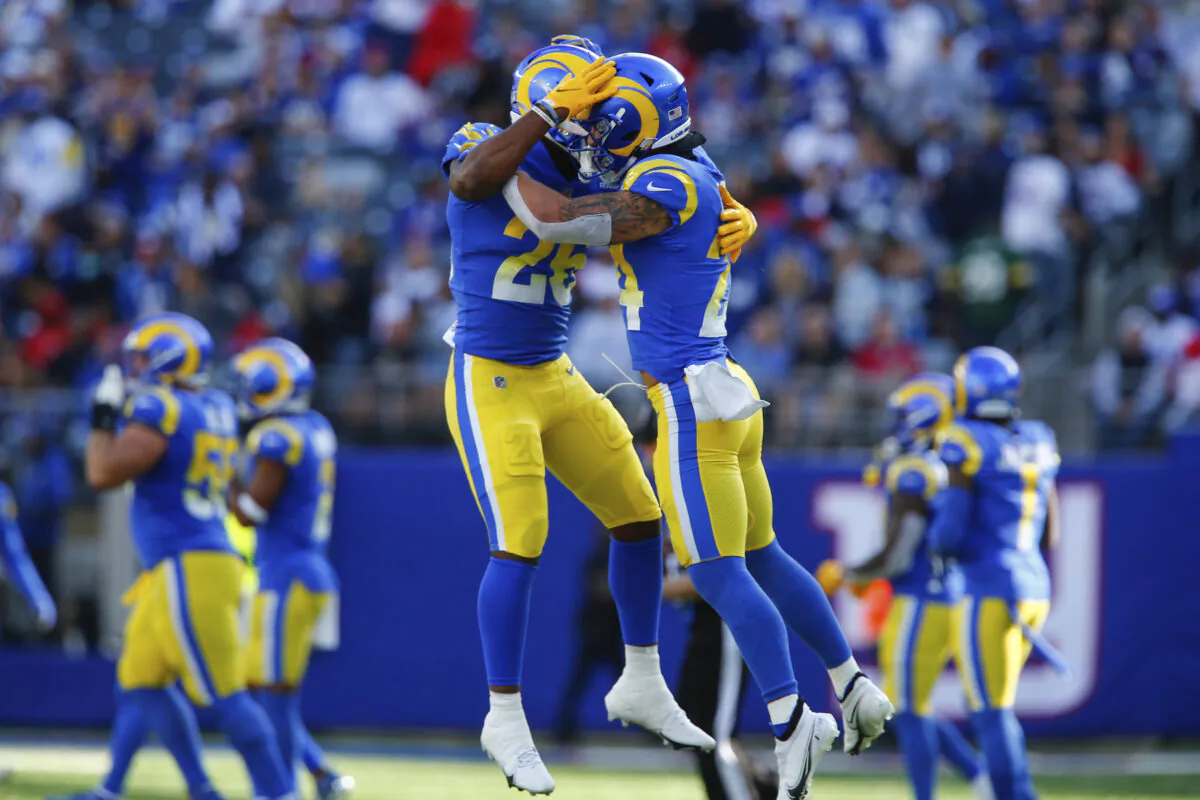Los Angeles Rams' Taylor Rapp, right, celebrates his interception with Terrell Burgess during the second half of an NFL football game against the New York Giants in East Rutherford, N.J., on Oct. 17, 2021. (AP Photo/John Munson)
