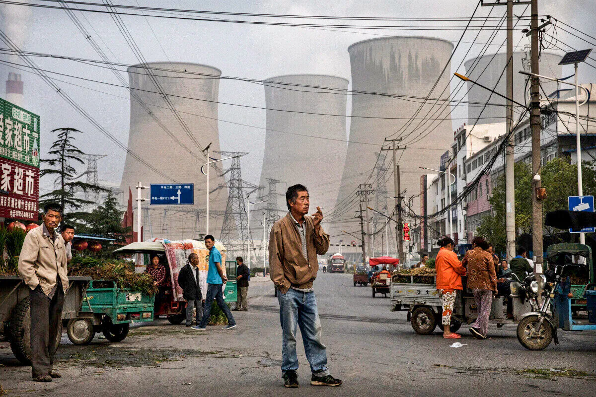 Chinese street vendors and customers gather at a local market outside a state owned coal-fired power plant in Anhui Province, China, on June 14, 2017. (Kevin Frayer/Getty Images)