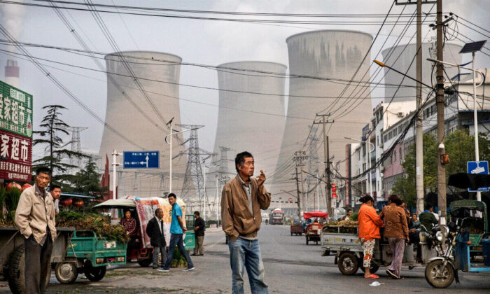 Chinese street vendors and customers gather at a local market outside a state owned coal fired power plant in Anhui Province, China on June 14, 2017. (Kevin Frayer/Getty Images)