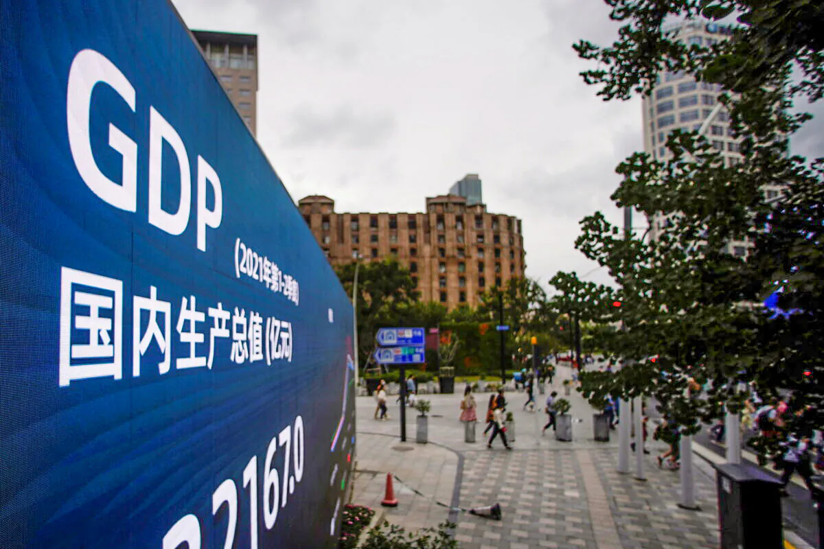 An electronic display showing the China GDP indexes is seen on a street in Shanghai on Oct. 16, 2021. (Reuters/Aly Song)