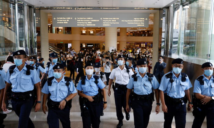 Police tell supporters to leave during the court hearing of Tong Ying-kit, the first person charged under a new national security law near the High Court, in Hong Kong, on July 30, 2021. (Tyrone Siu/Reuters)