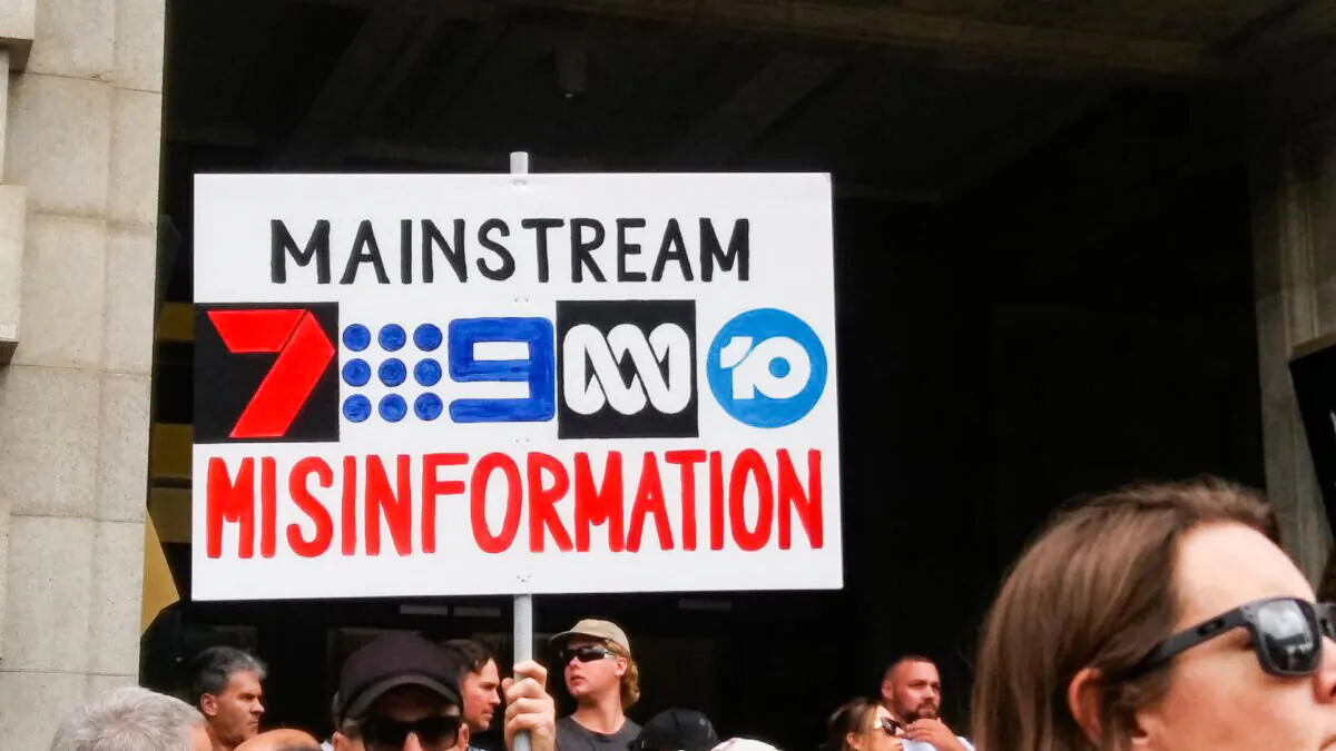 Protestors hold a sign at an anti-vaccination mandate rally in Perth, Australia on Oct. 16, 2021. (Daniel Khmelev/The Epoch Times)