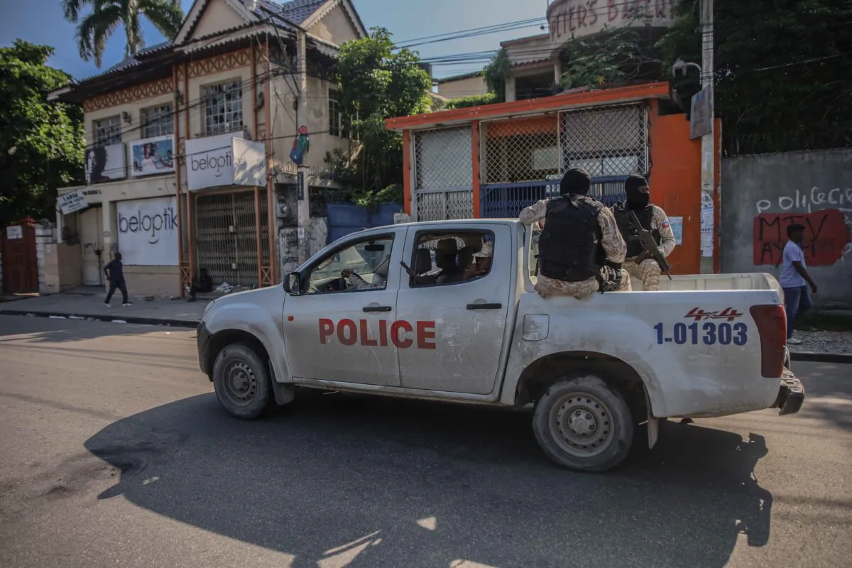 Armed police ride in the back of a truck after the streets of the Haitian capital, Port-au-Prince, were deserted following a call for a general strike launched by several professional associations and companies to denounce insecurity in Port-au-Prince, on Oct. 18, 2021. (Richard Pierrin/AFP via Getty Images)