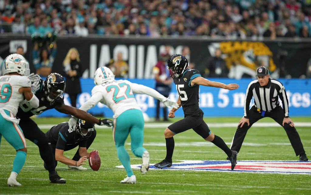 Jacksonville Jaguars kicker Matthew Wright #15 (2nd R) kicks a field goal during the second half of an NFL football game between the Miami Dolphins and the Jacksonville Jaguars at the Tottenham Hotspur stadium in London, England, on Sunday, Oct. 17, 2021. (Matt Dunham/AP Photo)
