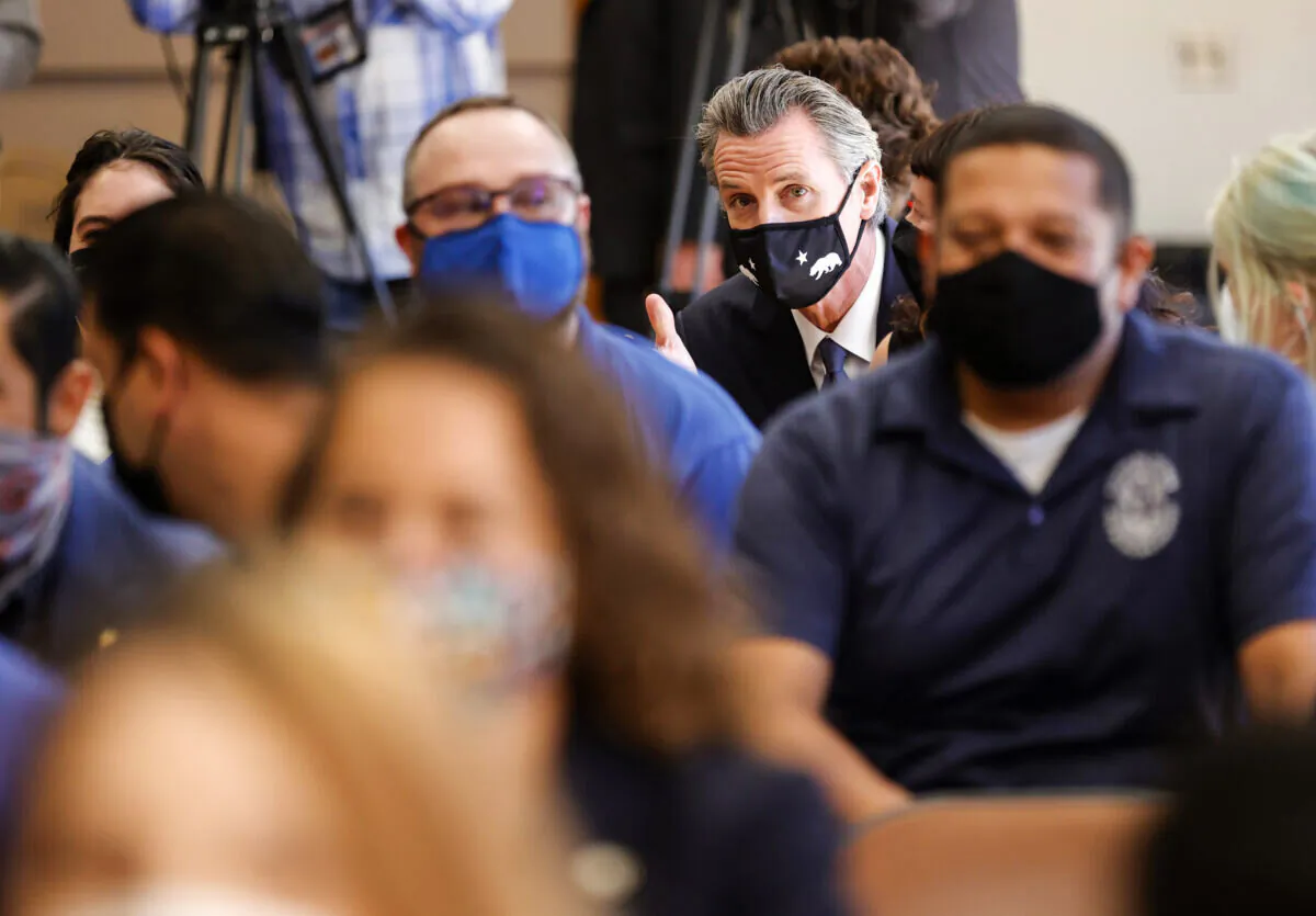 California Gov. Gavin Newsom sits in the crowd before speaking to union workers and volunteers at the IBEW Local 6 union hall in San Francisco, Calif., on Sept. 14, 2021. (Justin Sullivan/Getty Images)
