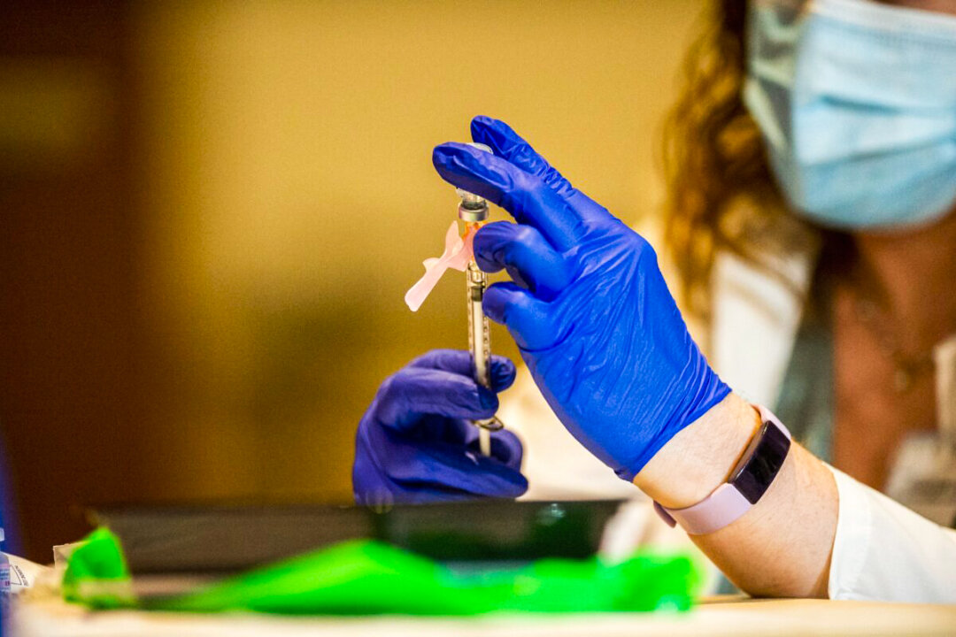 Pharmacist Colleen Teevan reconstitutes the Pfizer-BioNTech vaccine before having it administered to people at the Hartford Convention Center in Hartford, Connecticut, on Jan. 4, 2021. (Joseph Prezioso/AFP via Getty Images)