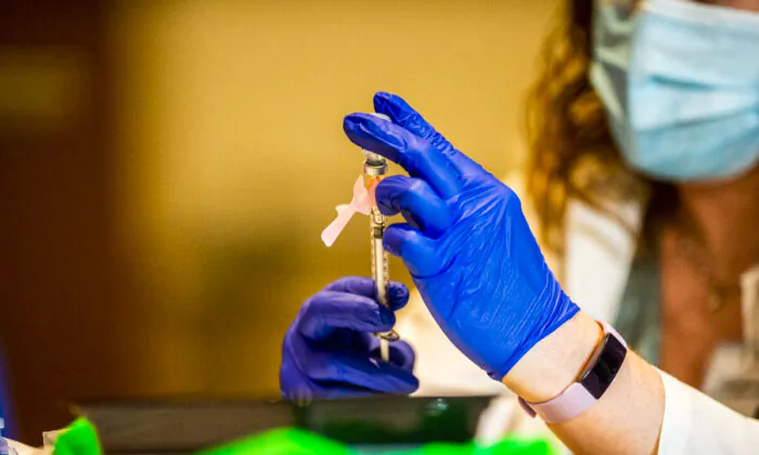 Pharmacist Colleen Teevan reconstitutes the Pfizer-BioNTech vaccine before having it administered to people at the Hartford Convention Center in Hartford, Connecticut, on Jan. 4, 2021. (Joseph Prezioso/AFP via Getty Images)