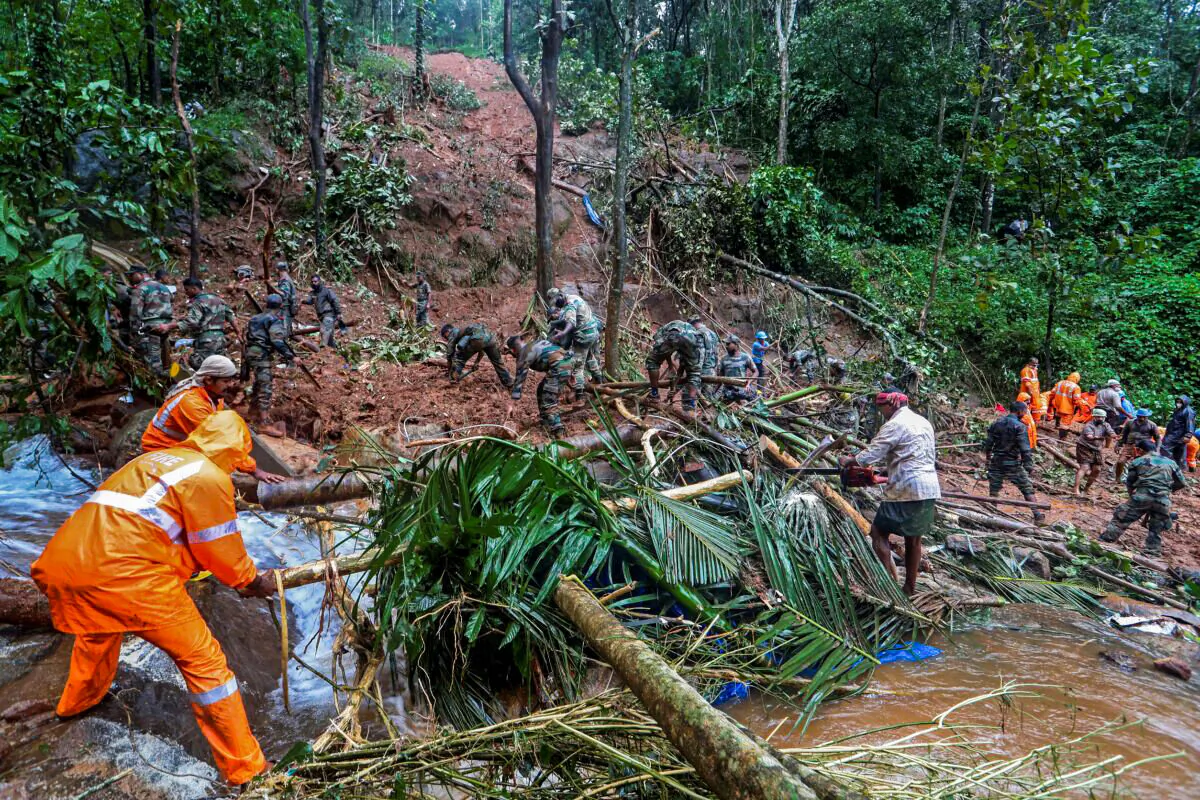 Rescuers search for bodies of victims amid the debris of a landslide following heavy rains at Koottickal in Kottayam district, southern Kerala state, India, on Oct. 17, 2021. (AP Photo)