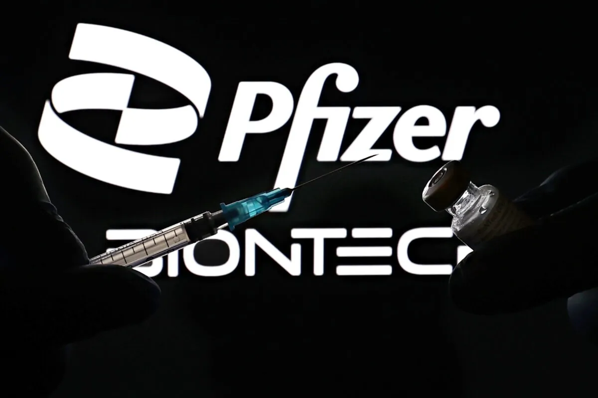 A medical syringe and vials of the Pfizer pharmaceutical corporation and BioNTech German biotechnology 2021 company logos are seen in New York City, on Oct. 3, 2021. (Cindy Ord/Getty Images for Pfizer/BioNTech)