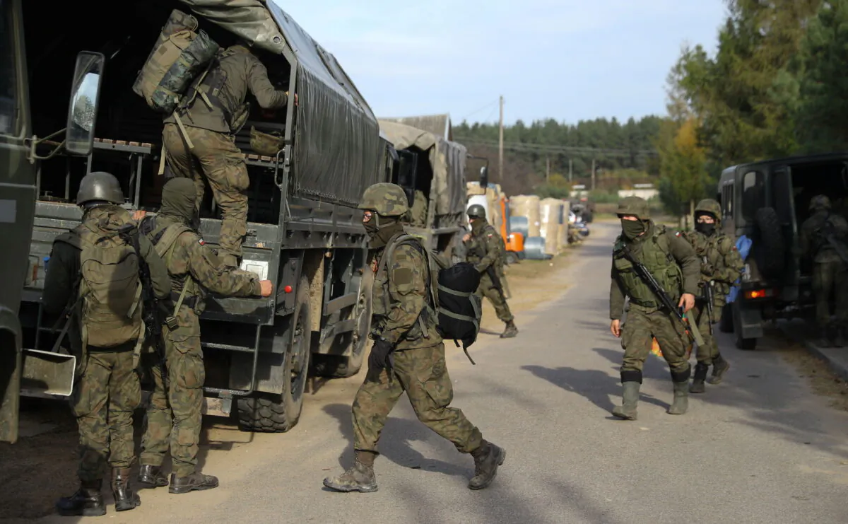 Polish Army soldiers are seen in front of the Border Guard headquarters in Michalowo, Poland, on Oct. 11, 2021. (Kacper Pempel/Retuers)