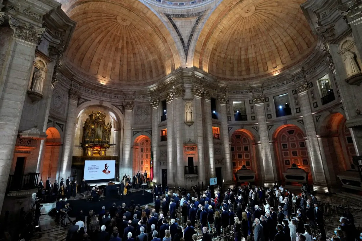 People stand for the national anthem at the end of a ceremony paying homage to Aristides de Sousa Mendes, at the National Pantheon in Lisbon, Portugal, on Oct. 19, 2021. (Armando Franca/AP Photo)