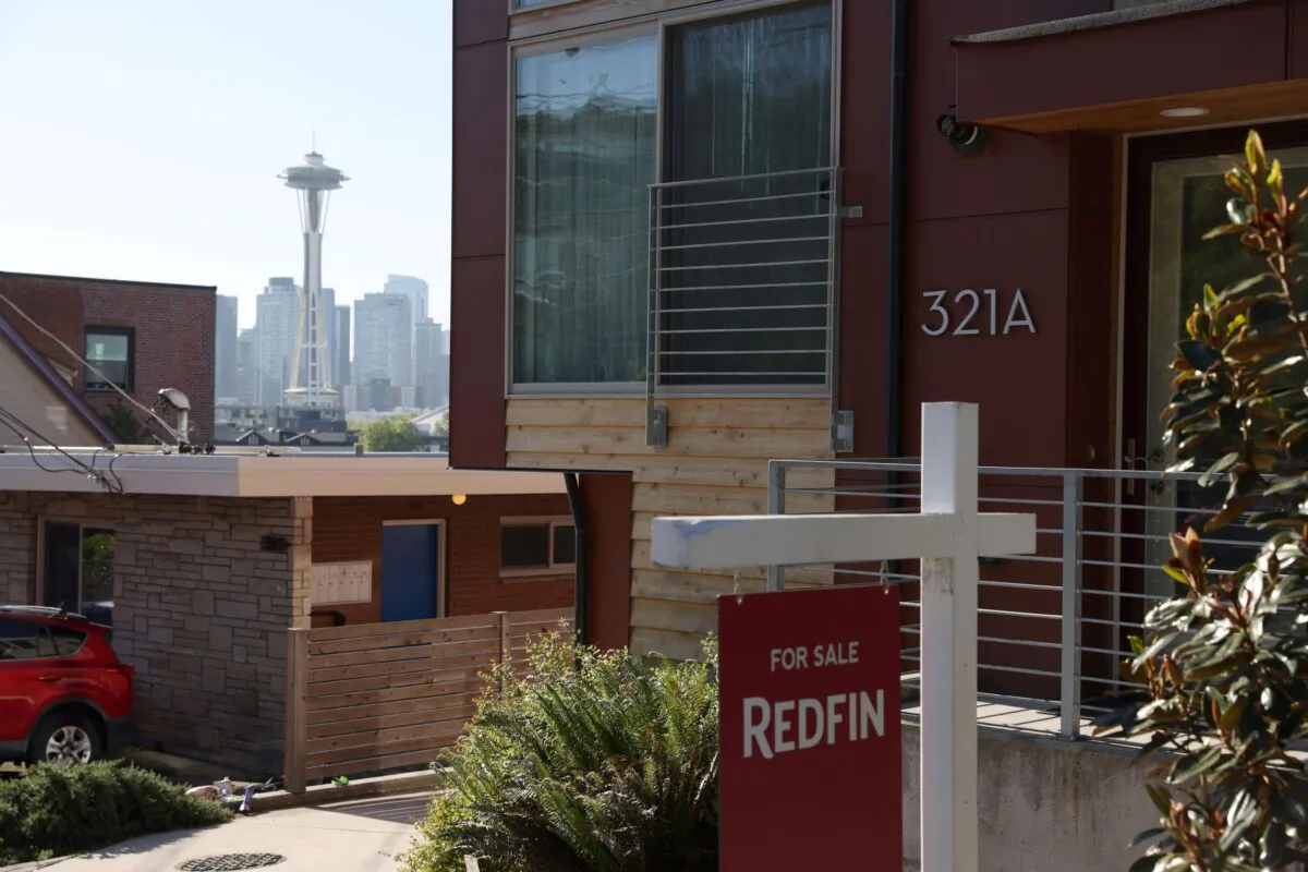 A "For Sale" sign is posted outside a residential home in the Queen Anne neighborhood near the Space Needle in Seattle, Washington on May 14, 2021. (Karen Ducey/Reuters)
