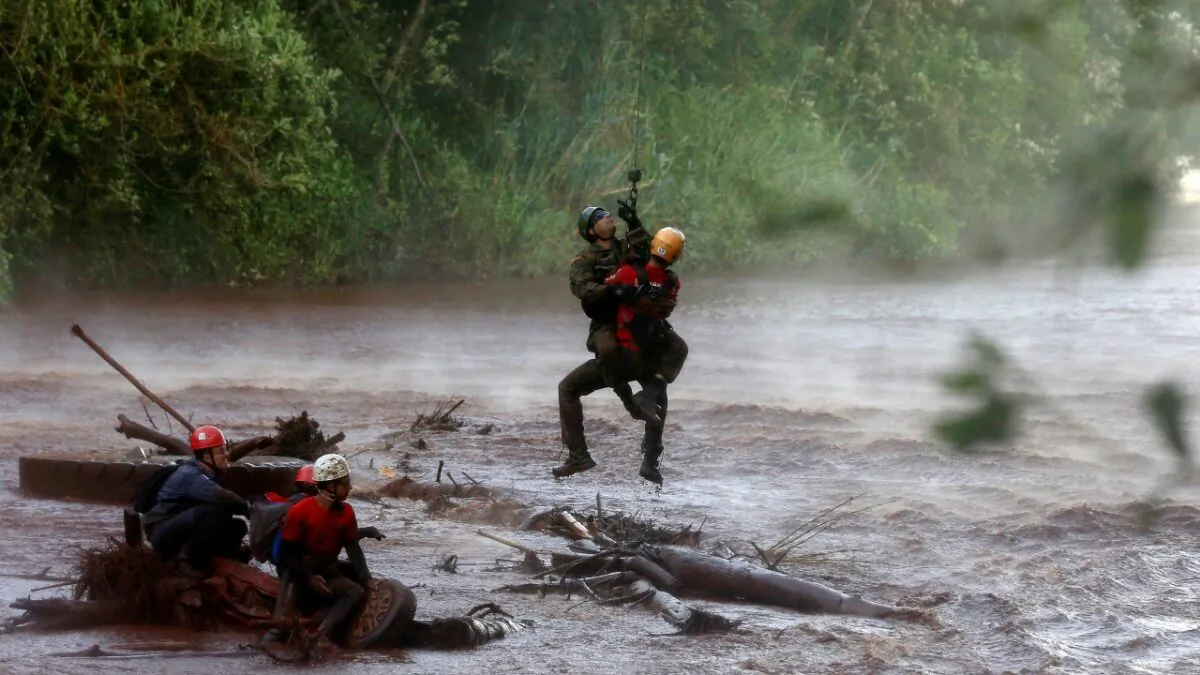 A soldier helps a member of a rescue team on Paraopeba River as they search for victims of a collapsed tailings dam owned by Brazilian mining company Vale SA, in Brumadinho, Brazil, on Feb. 5, 2019. (Adriano Machado/Reuters)