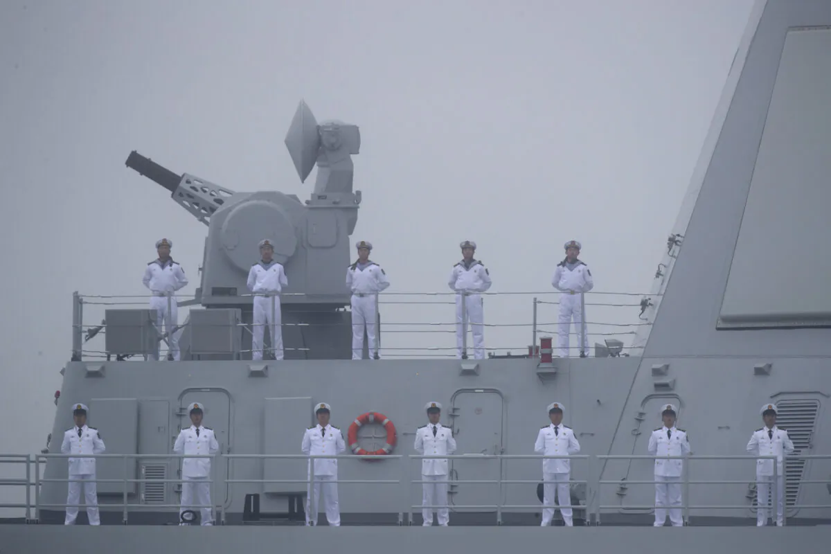 Sailors stand on the deck of the new type 055 guide missile destroyer Nanchang of the Chinese People's Liberation Army (PLA) Navy as it participates in a naval parade to commemorate the 70th anniversary of the founding of China's PLA Navy in the sea near Qingdao, Shandong Province, China, on April 23, 2019. (Mark Schiefelbein/AFP via Getty Images)