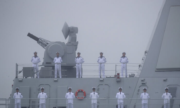 Sailors stand on the deck of the new type 055 guide missile destroyer Nanchang of the Chinese People's Liberation Army (PLA) Navy as it participates in a naval parade to commemorate the 70th anniversary of the founding of China's PLA Navy in the sea near Qingdao, in eastern China's Shandong Province on April 23, 2019.  (Mark Schiefelbein/AFP via Getty Images)