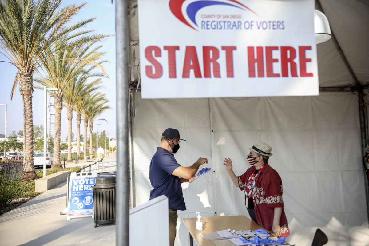 A voter signs-in to cast his ballot at the San Diego County Registrar of Voters in San Diego on Oct. 5, 2020. (Sandy Huffaker/AFP via Getty Images)