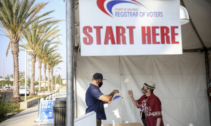 A voter signs-in to cast his ballot at the San Diego County Registrar of Voters in San Diego on Oct. 5, 2020. (Sandy Huffaker/AFP via Getty Images)