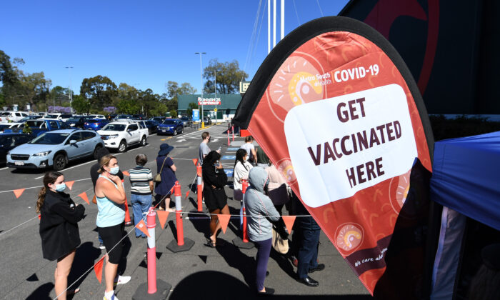 People queue to receive a Covid-19 vaccine at a Bunnings hardware store in Brisbane, Australia, on Oct. 16, 2021. (Dan Peled/Getty Images)