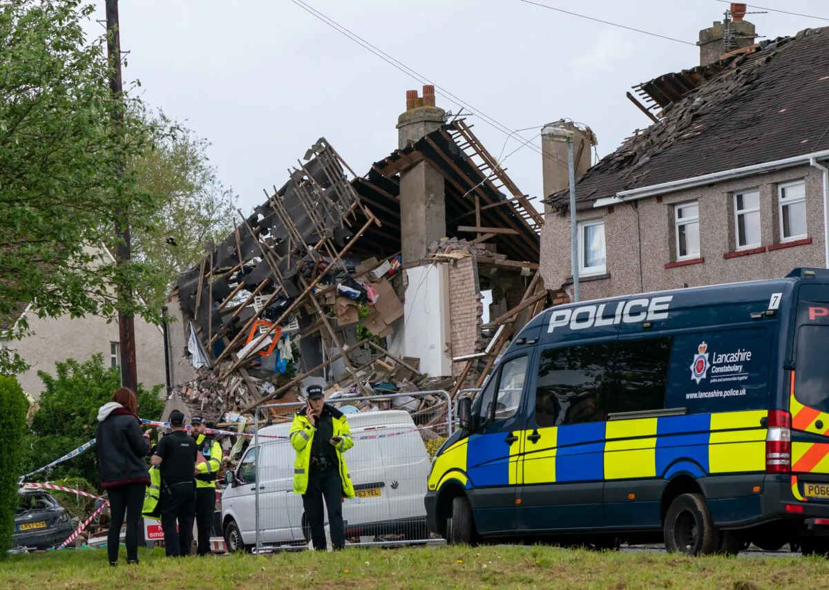 Emergency workers at the scene of a suspected gas explosion, in which a young child was killed and two people were seriously injured, on Mallowdale Avenue, Heysham, UK, on May 16, 2021. (Danny Lawson/PA)