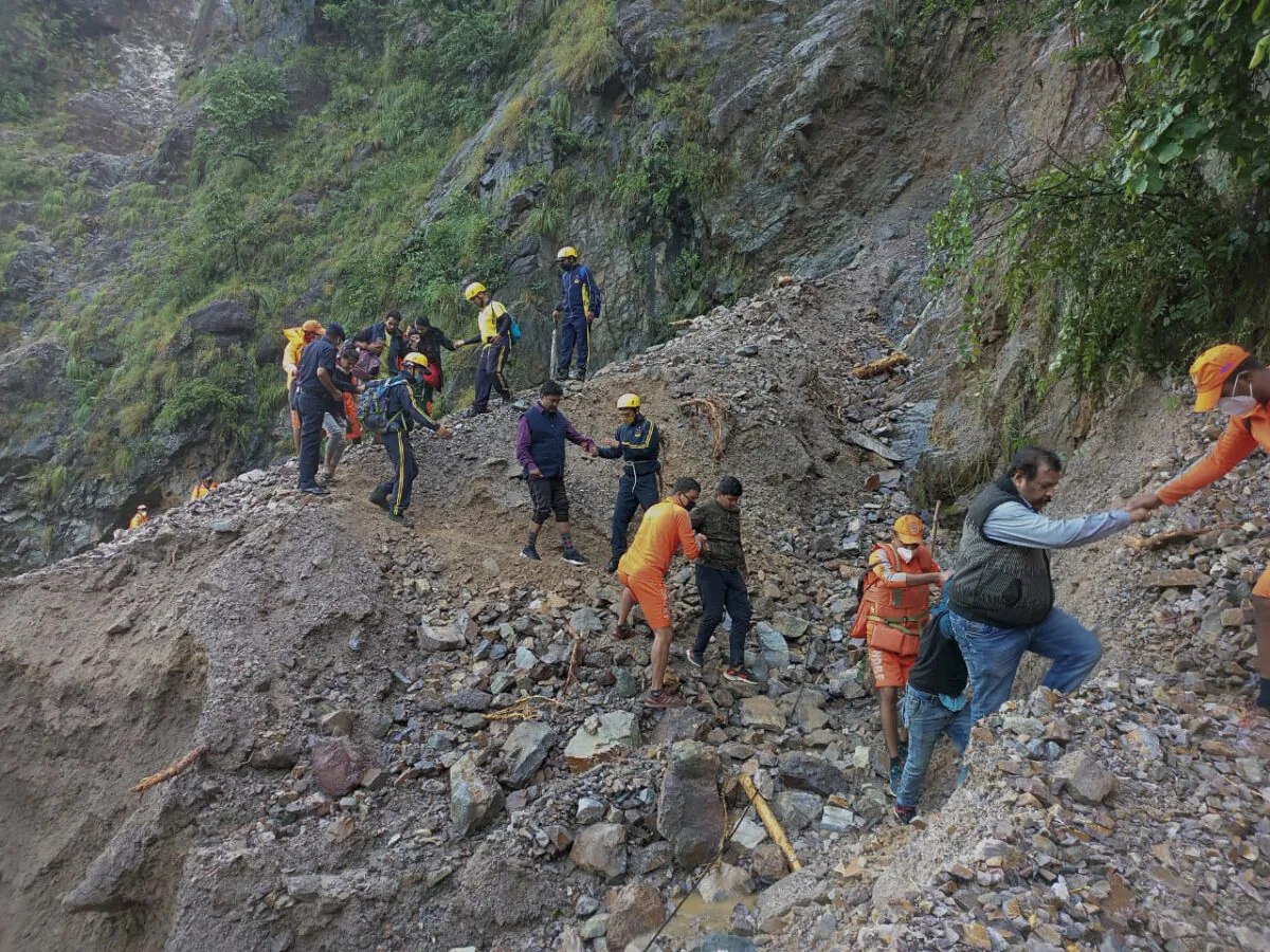 NDRF personnel rescue civilians stranded following heavy rains at Chhara village near Nainital, Uttarakhand, India, on Oct. 20, 2021. (National Disaster Response Force via AP