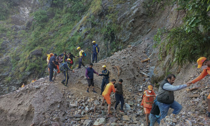 NDRF unit   rescue civilians stranded pursuing  dense  rains astatine  Chhara colony   adjacent   Nainital, Uttarakhand, India, connected  Oct. 20, 2021. (National Disaster Response Force via AP