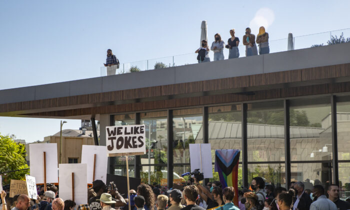 Protestors and counter-protestors voicing for or against a popular Dave Chapelle comedy special currently airing on Netflix gather in front of Netflix's Vine Street offices in Los Angeles on Oct. 20, 2021. (John Fredricks/The Epoch Times)