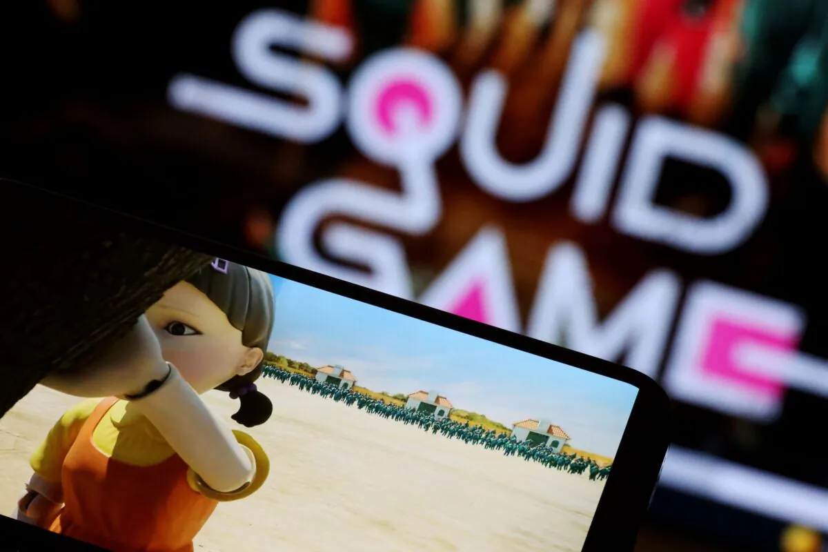 The Netflix series "Squid Game" is played on a mobile phone in this picture illustration taken on Sept. 30, 2021. China’s biggest streaming platform ,Youku, has been accused of plagiarizing the popular TV shows. (Kim Hong-Ji/Illustration/Reuters)