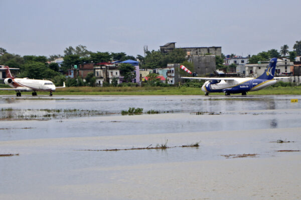 Aircraft stand on the tarmac of a flooded domestic airport after heavy rains in Biratnagar, Nepal, on Oct. 20, 2021. (Lila Ballav Ghimire/AFP via Getty Images)