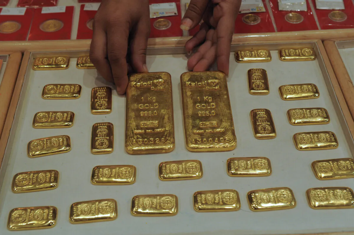 An Indian saleswoman arranges gold bars at a jewellery store in Ahmedabad in a file photo. (Sam Panthaky/AFP via Getty Images)