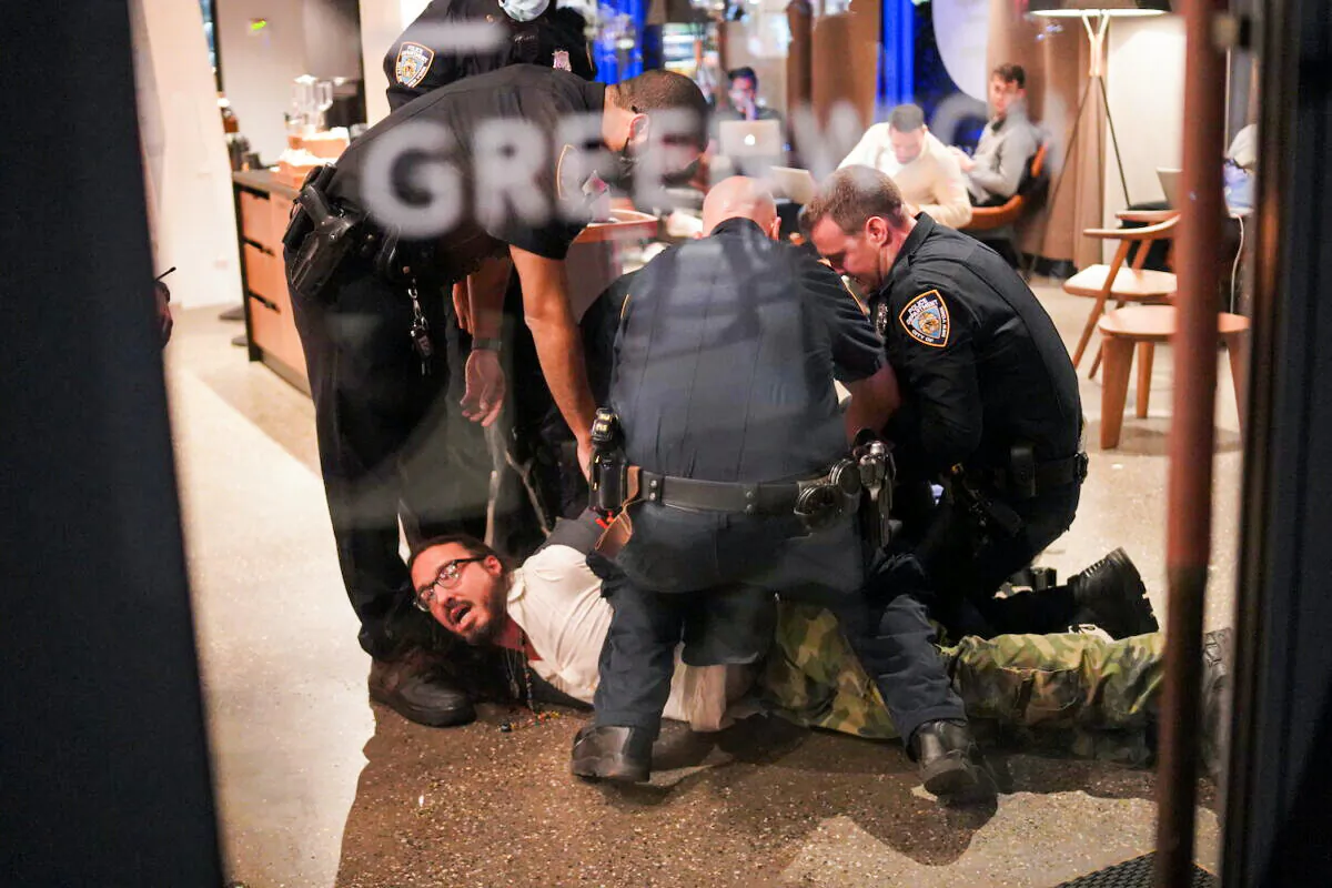 Michael Molinaro is arrested by NYPD in lower Manhattan, New York, on Oct. 19, 2021 (Enrico Trigoso/The Epoch Times)