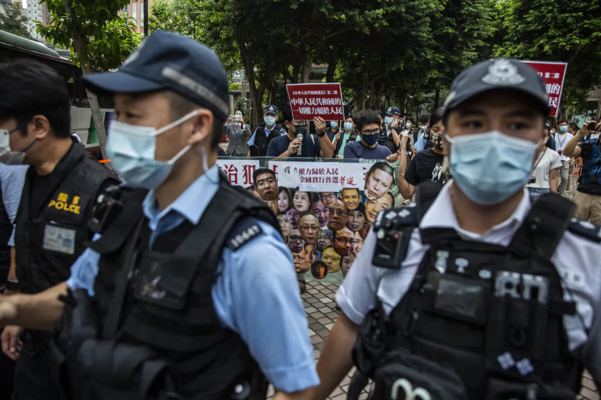 Pro-democracy activists (C) from the League of Social Democrats protest in the Wan Chai district of Hong Kong on Oct. 1, 2021. (Isaac Lawrence/AFP via Getty Images)